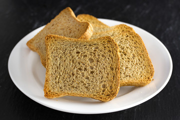 toasts on plate on dark background
