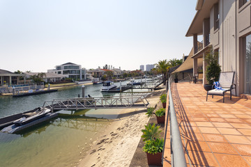 lake and pier behind modern australian mansion