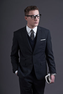 Retro fifties fashion young businessman with black glasses weari