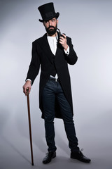 Retro hipster 1900 fashion man with black hair and beard. Wearin