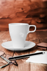 Coffee Cup and office supplies on old wood table