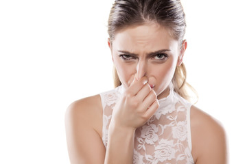 girl pinches her nose with her fingers