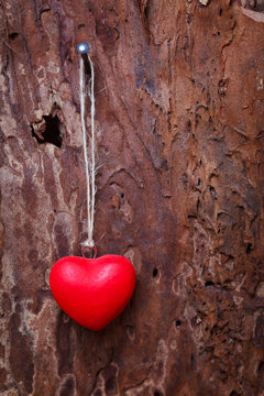 red heart hanging before wooden board