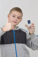 Young beautiful boy with perfume