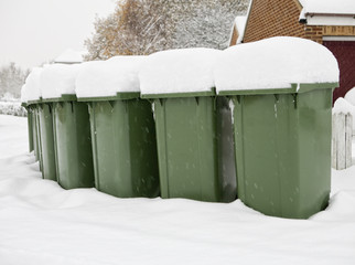 Refuse bins out for collection in the snow