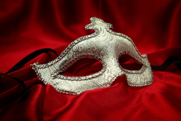 Vintage venetian carnival mask on velvet background