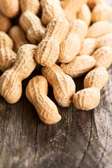 Peanuts in shell on wooden table vertical