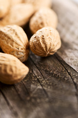 Peanuts in shell on wooden table vertical close up