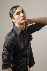 Young man dressed in a black shirt and thinking