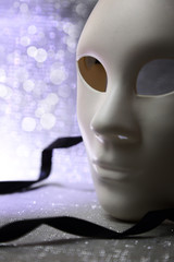 White mask with glittering background