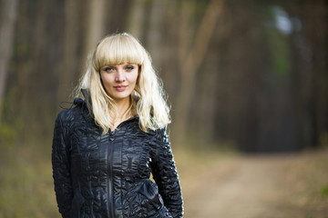 Beautiful young woman walks on autumn park