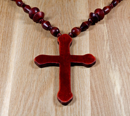 Christian cross on wooden surface