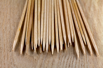 The pile of toothpicks on wooden surface