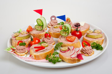 party platter with sandwiches with pate and vegetables