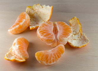 Tangerine and peel on wooden surface