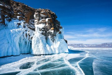 Baikal Lake. Ice and icicles on a rocky island in sunny day