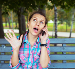 Portrait beautiful woman in the park talking on the phone