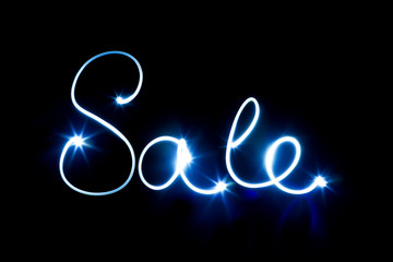 Glowing inscription SALE on a black