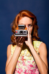 Girl with retro style polaroid camera.