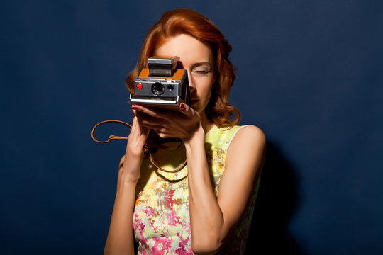 Girl with retro style polaroid camera.