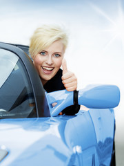 Woman shows thumb up for driving enjoyment