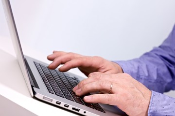 Business man typing on a laptop