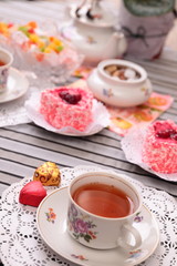 Obraz na płótnie Canvas Warm cup of tea and sweets