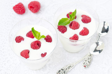 panna cotta with fresh raspberries in glasses top view