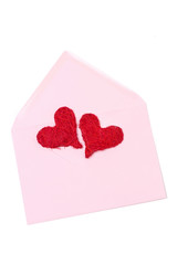two red hearts in a pink envelope, isolated