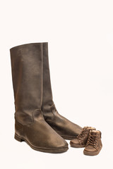 Two pairs of boots - big and small. Military and kid sized boots