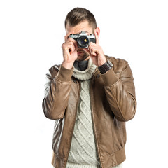 Man photographing a girl over white background