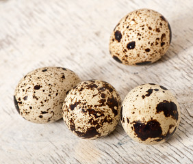 Quail eggs on a old wooden table