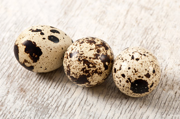 Quail eggs on a old wooden table