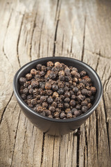 Black pepper spice in black bowl