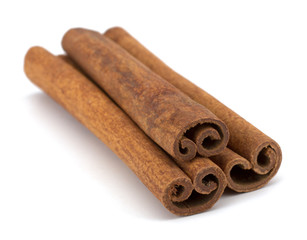 cinnamon sticks stacked on white background