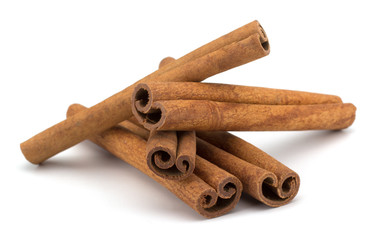 cinnamon sticks stacked on white background