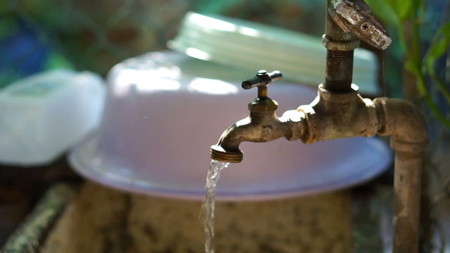 A dolly shot of a Running water faucet