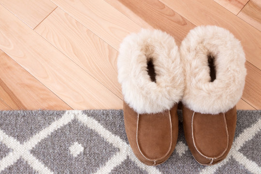 Rug and slippers on wooden floor