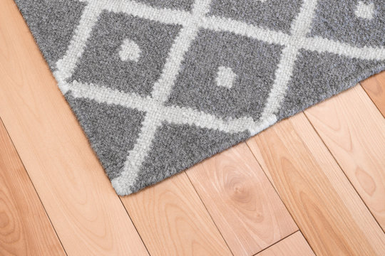 Gray rug on wooden floor