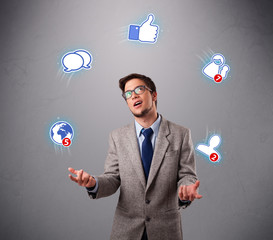 handsome young boy juggling with social media icons