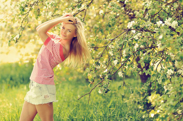 Young sexy girl posing in a summer green park