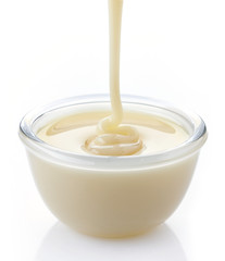 pouring condensed milk with sugar in a bowl