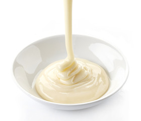 pouring condensed milk with sugar in a bowl