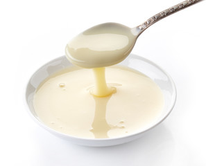 pouring condensed milk with sugar in a bowl