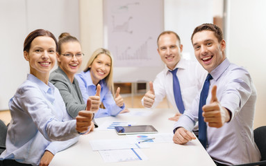 business team showing thumbs up in office