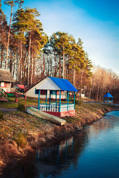 A gazebo located on the shore of a small lake