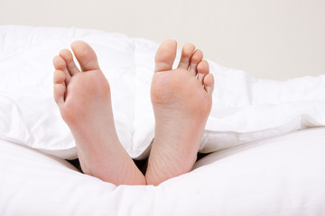 feet in the foreground in the covered bed