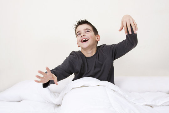 cute little boy with expressions in bed