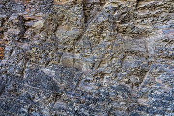The close-up relief of the rocks with a layered structure.