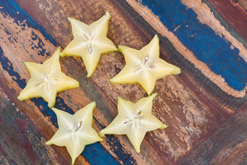 Five stars of carambola on wooden table